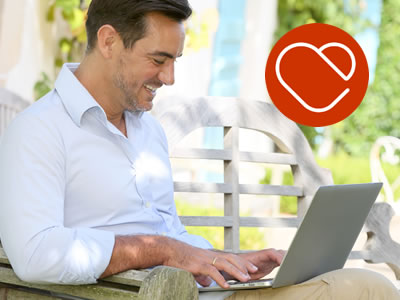 mature man looking for love online using a laptop
